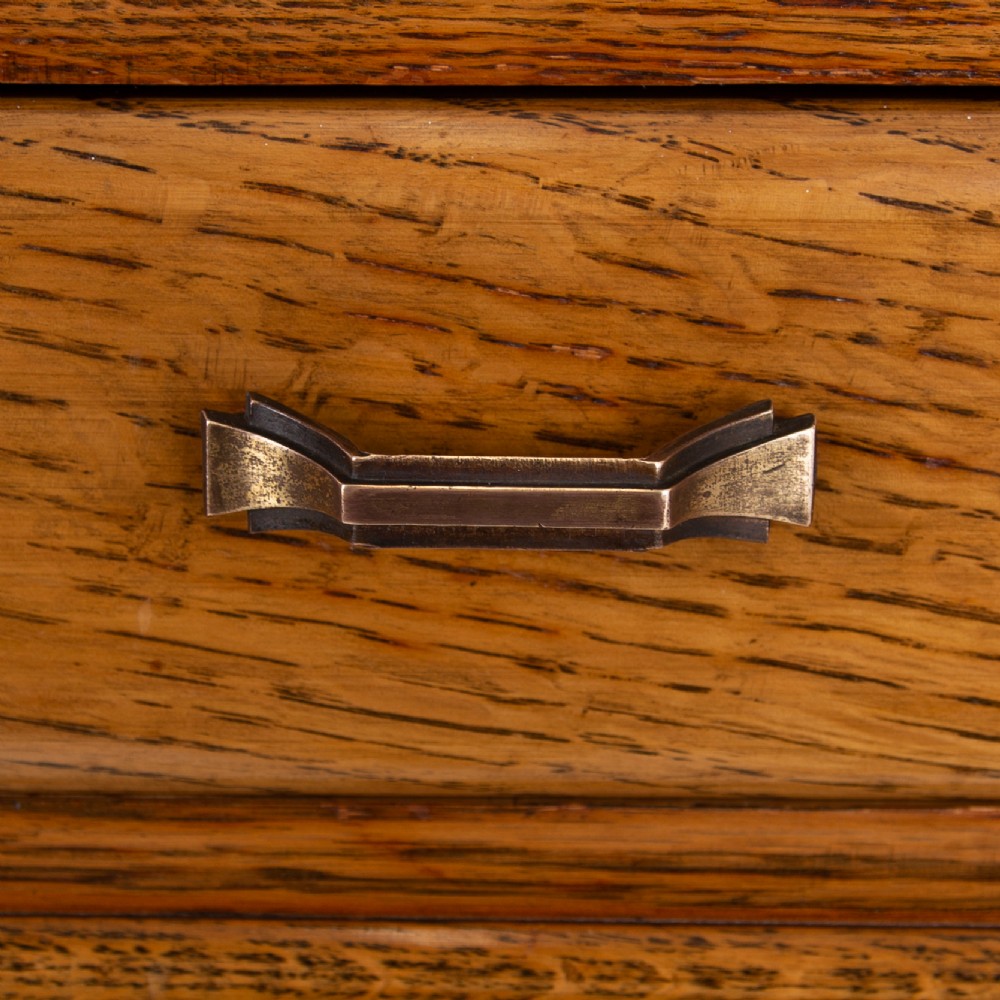 A 1930s Art Deco oak bachelors wardrobe featuring a top drawer, a central cupboard door with rounded framing, and carved corner accents. View XI