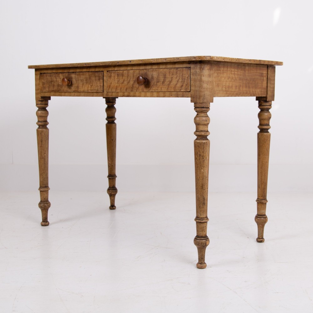 A 19th-century pine side table featuring two drawers with wooden knob handles, supported by slender turned legs. View II