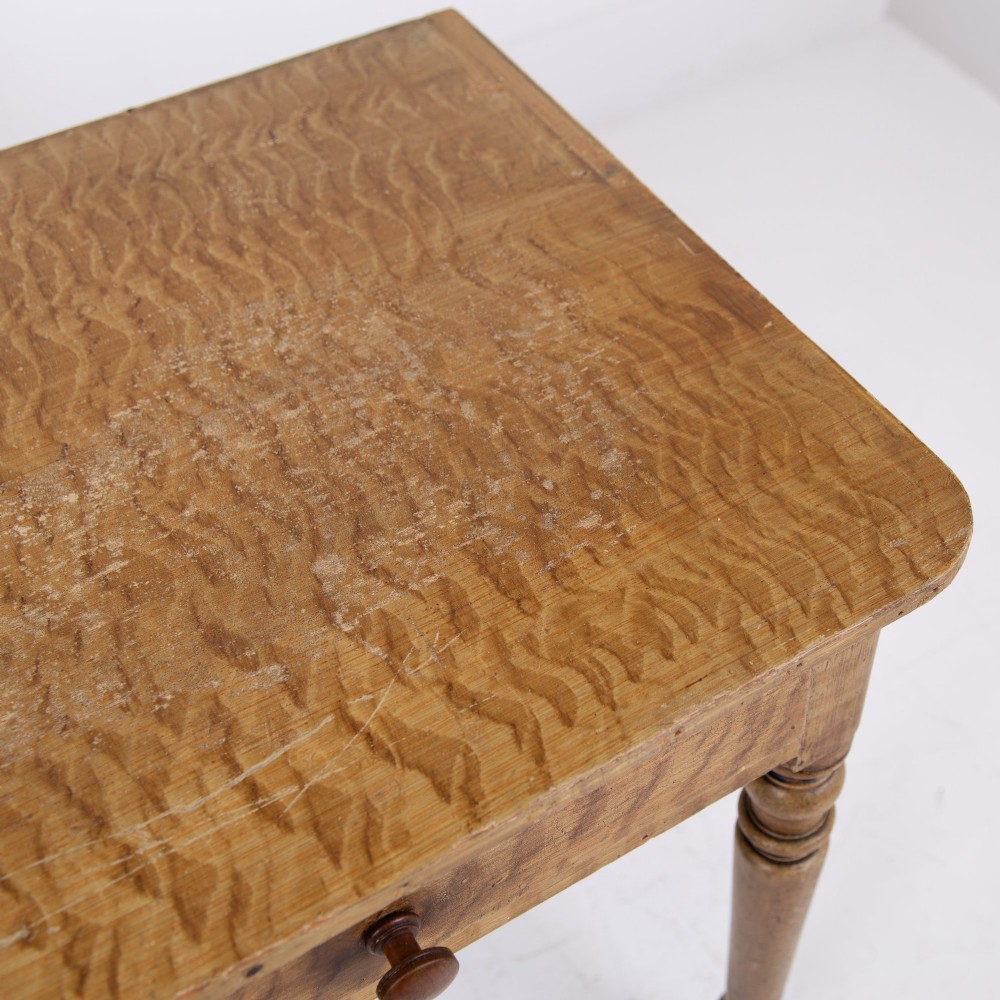 A 19th-century pine side table featuring two drawers with wooden knob handles, supported by slender turned legs. View VII