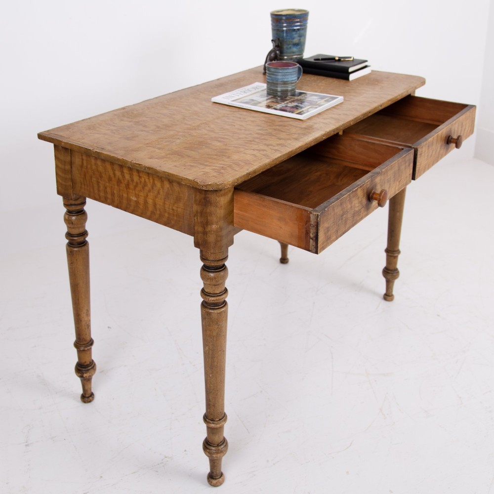 A 19th-century pine side table featuring two drawers with wooden knob handles, supported by slender turned legs. View VIII