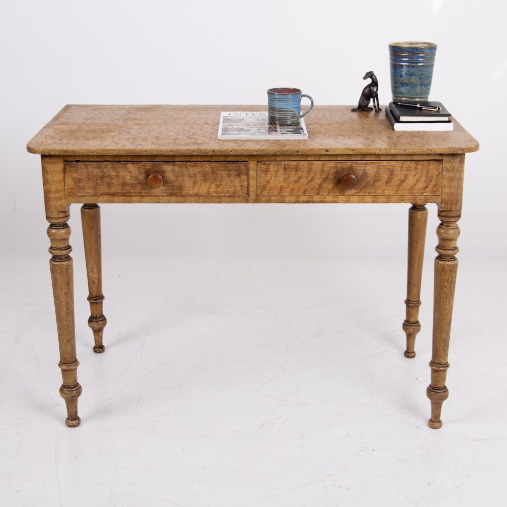 A 19th-century pine side table featuring two drawers with wooden knob handles, supported by slender turned legs. View IX