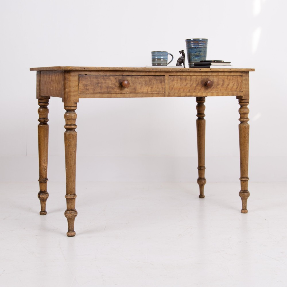 A 19th-century pine side table featuring two drawers with wooden knob handles, supported by slender turned legs. View XV