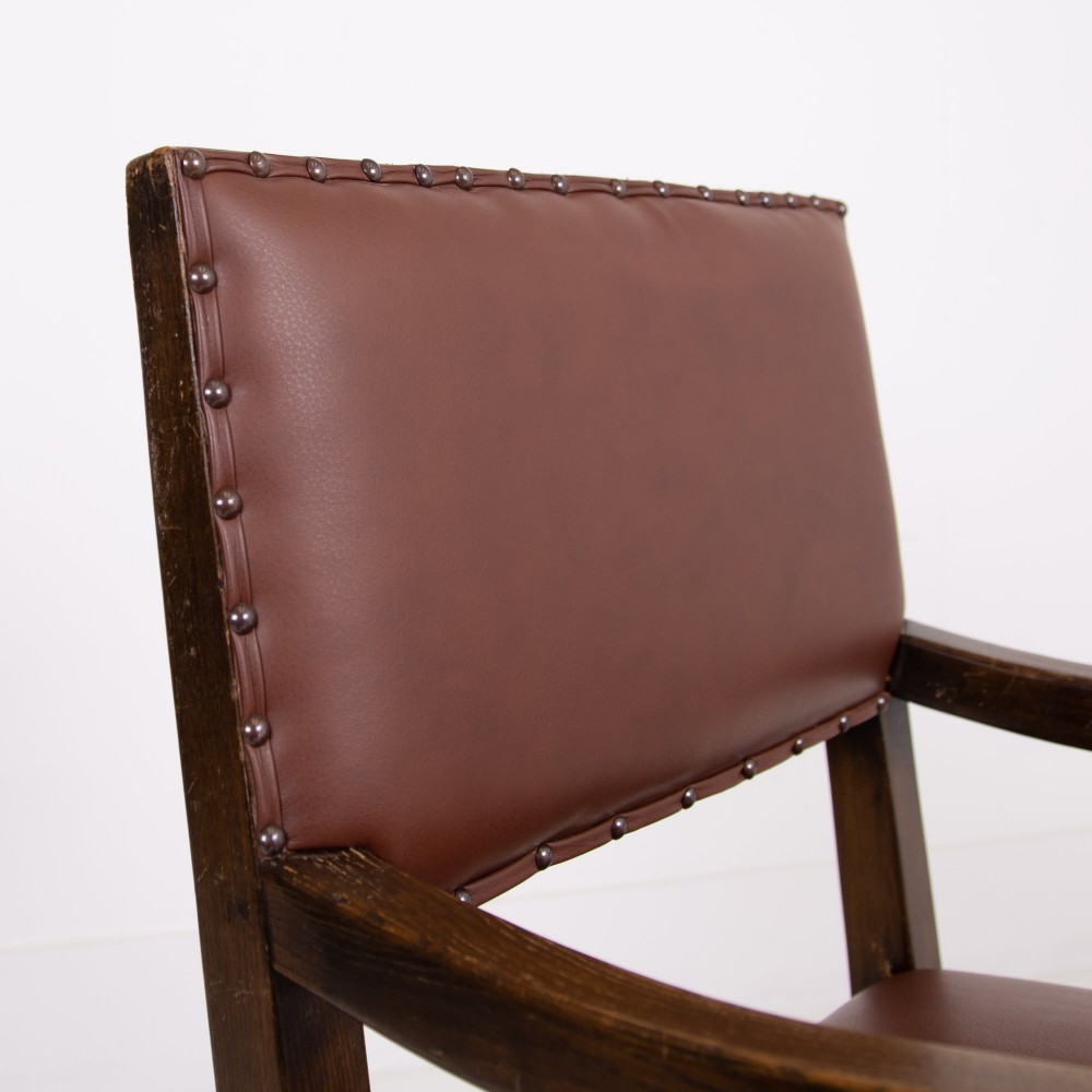 A set of six dark oak dining chairs featuring brown leather upholstered seats and backrests with brass stud detailing and turned front legs. View XIII