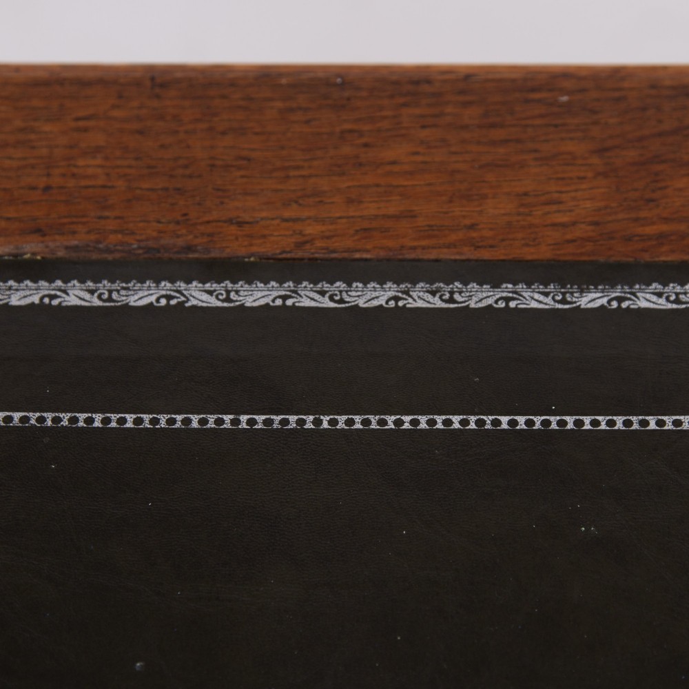 A 1920s English oak writing table featuring two frieze drawers with metal drop handles and four slender tapered legs. View VII