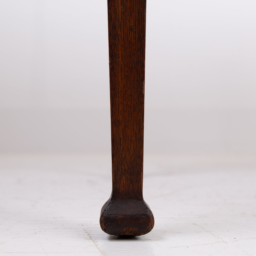 A 1920s English oak writing table featuring two frieze drawers with metal drop handles and four slender tapered legs. View XIII