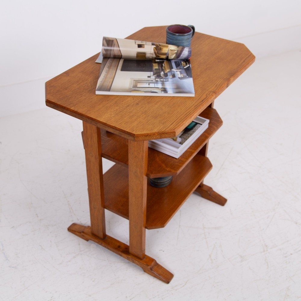 An antique Cotswold School solid oak side table featuring three rectangular shelves supported by straight uprights and sled feet. View III