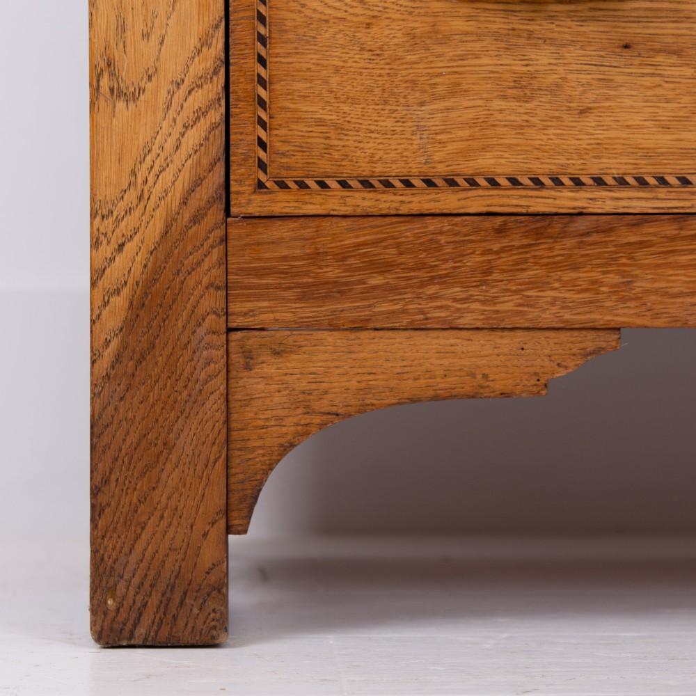 An Edwardian single-door oak wardrobe featuring a central vertical mirror, recessed side panels, a single base drawer, and a stepped top cornice. View VI