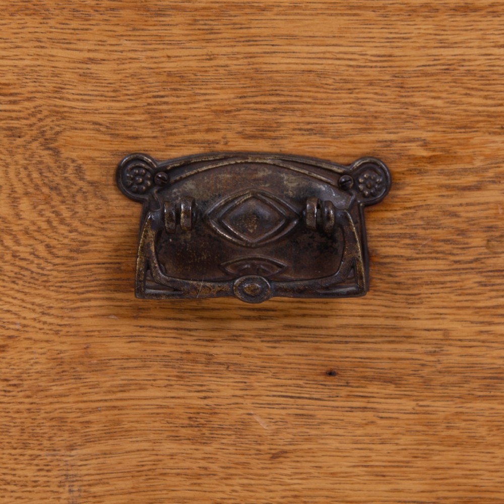 An Edwardian single-door oak wardrobe featuring a central vertical mirror, recessed side panels, a single base drawer, and a stepped top cornice. View VIII