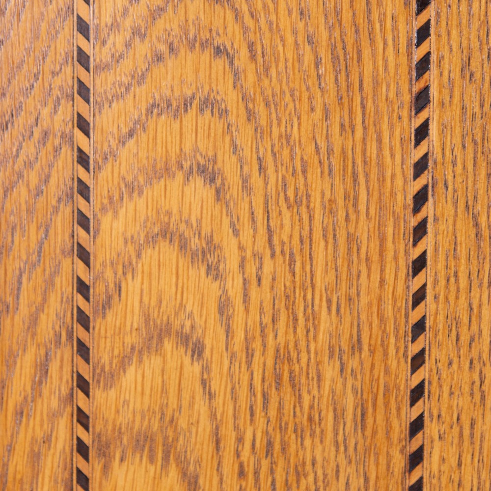 An Edwardian single-door oak wardrobe featuring a central vertical mirror, recessed side panels, a single base drawer, and a stepped top cornice. View XI