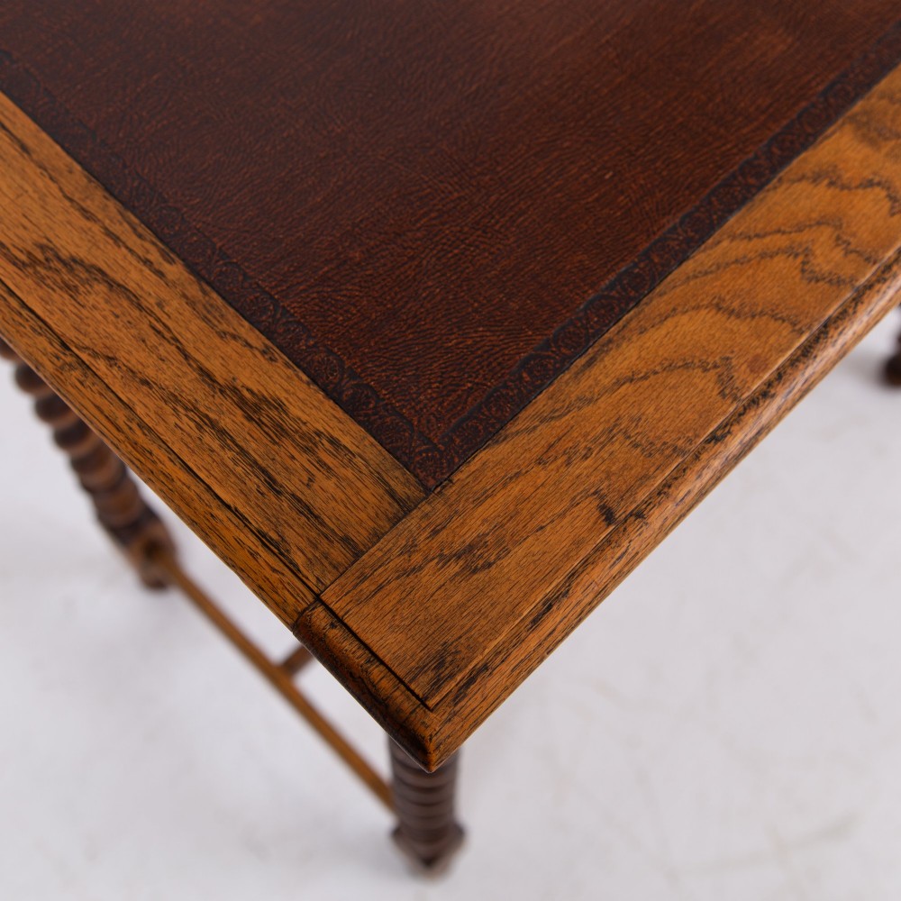 An antique English oak side table featuring a single drawer with metal drop handles, set upon four barley twist legs connected by an H-stretcher base. View IX