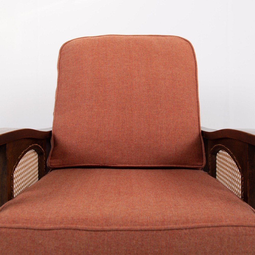 A pair of dark oak Edwardian armchairs featuring barley twist front supports, woven cane side panels, and thick terracotta fabric cushions. View VII