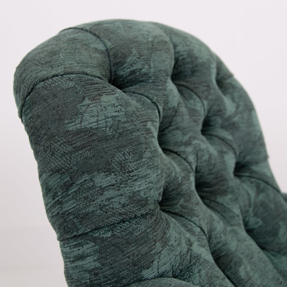 A profile view of a Victorian walnut open library armchair with dark green button-backed upholstery, turned front legs, and brass castors. View X