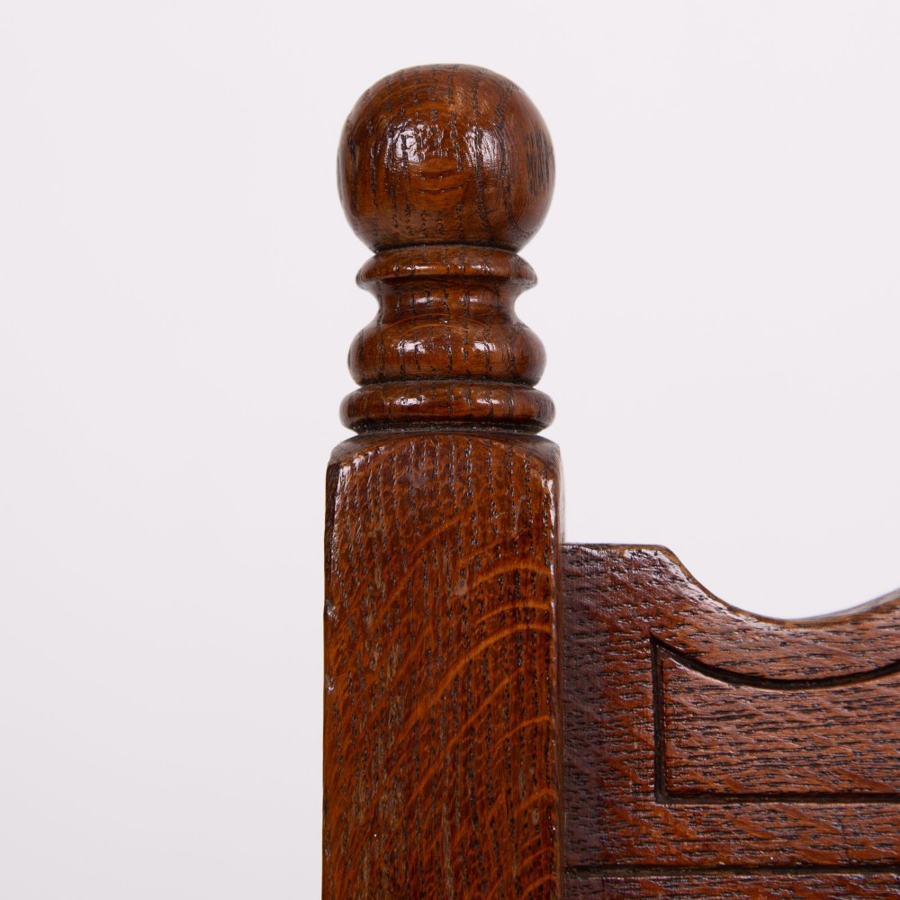 A set of six dark oak country dining chairs featuring hand-woven rush seats, carved top rails, and turned front legs. View X