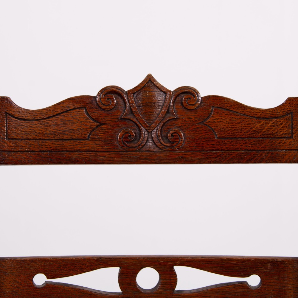 A set of six dark oak country dining chairs featuring hand-woven rush seats, carved top rails, and turned front legs. View XI