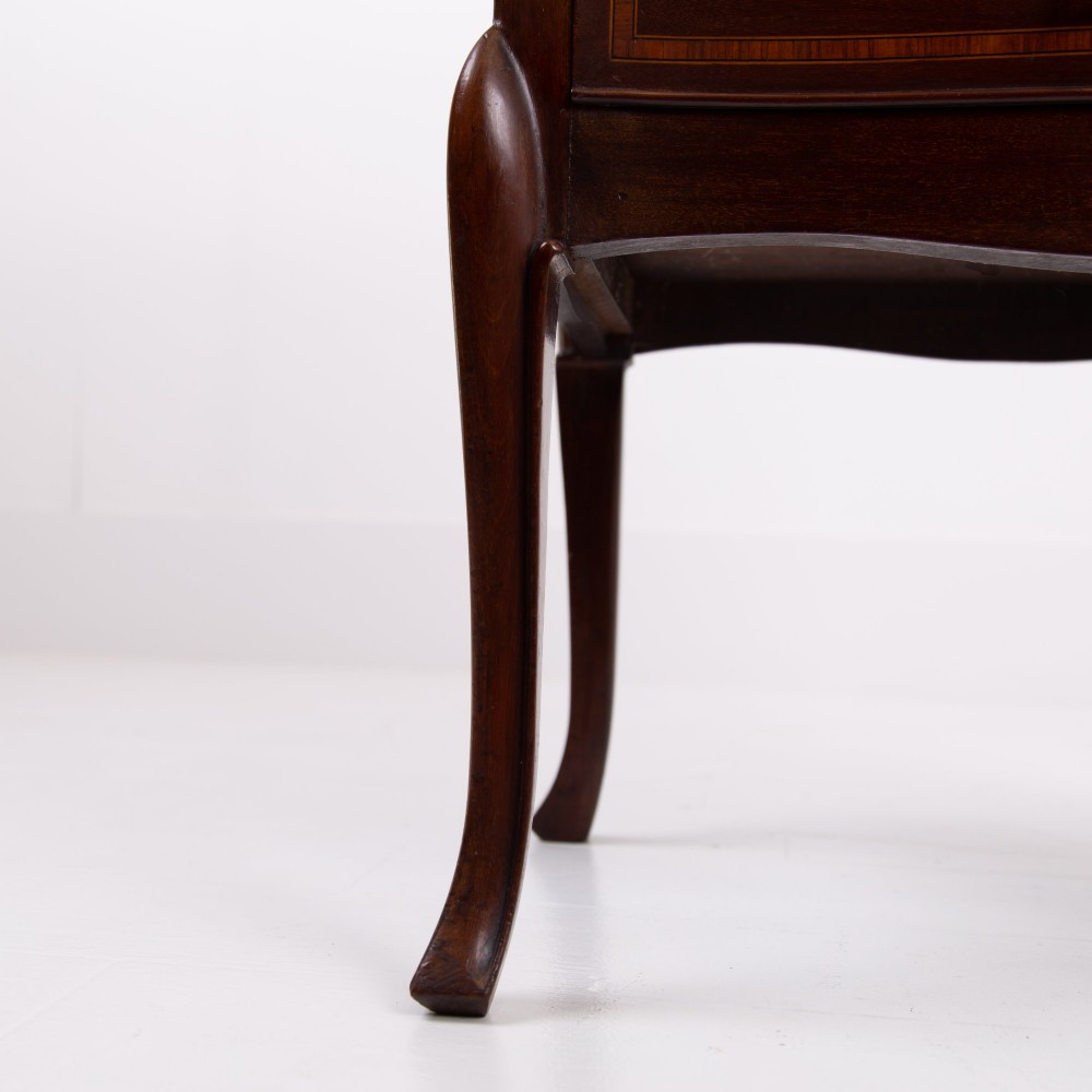 A matching pair of dark mahogany Edwardian cabinets featuring five inlaid drawers, slender cabriole legs, and an open top tray shelf. View IX