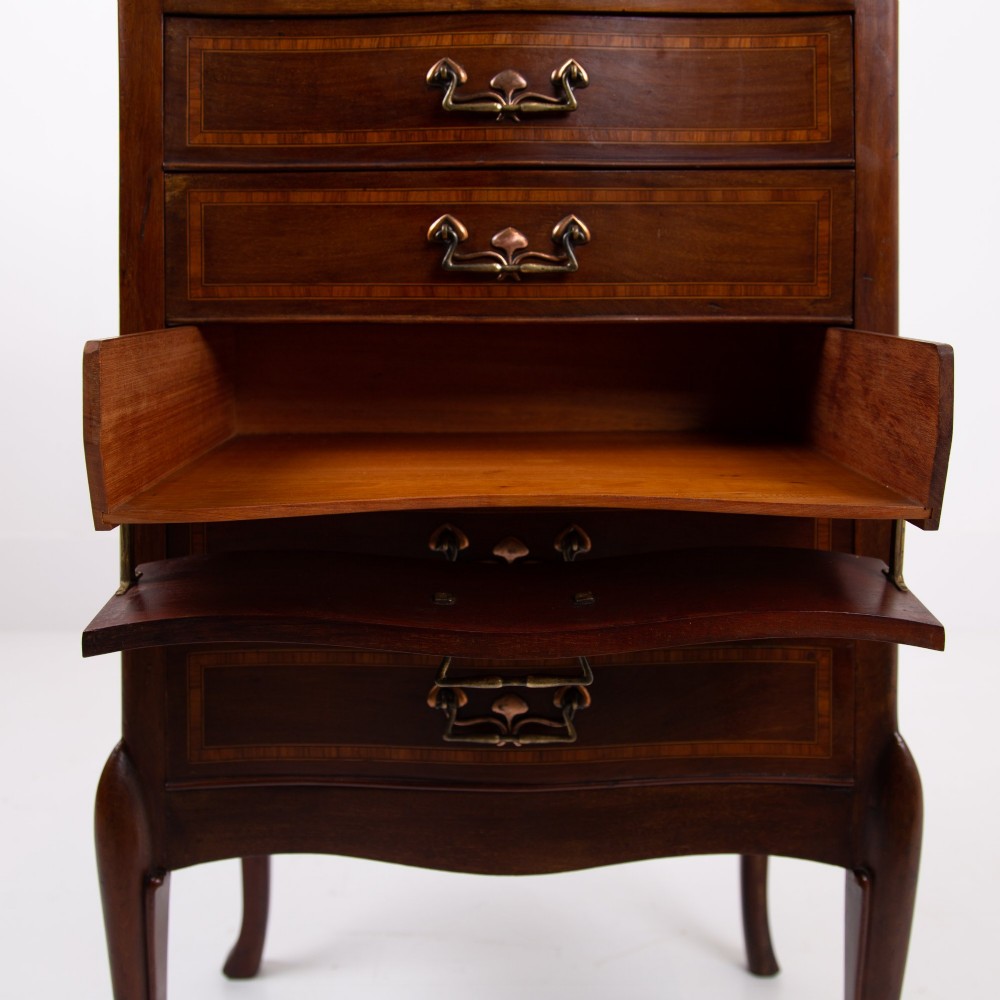 A matching pair of dark mahogany Edwardian cabinets featuring five inlaid drawers, slender cabriole legs, and an open top tray shelf. View X