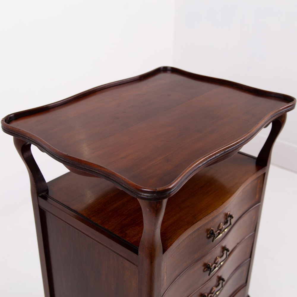 A matching pair of dark mahogany Edwardian cabinets featuring five inlaid drawers, slender cabriole legs, and an open top tray shelf. View XI