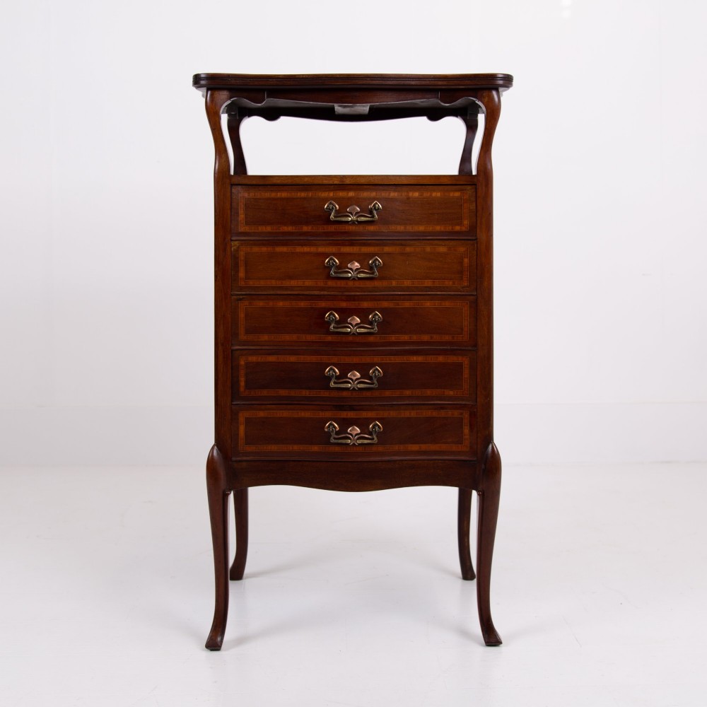 A matching pair of dark mahogany Edwardian cabinets featuring five inlaid drawers, slender cabriole legs, and an open top tray shelf. View XV