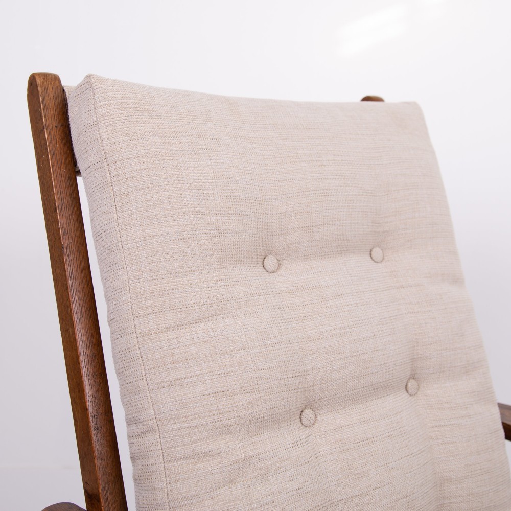 An Arts and Crafts oak reclining armchair featuring a beige buttoned cushion and pierced side splats. View VI