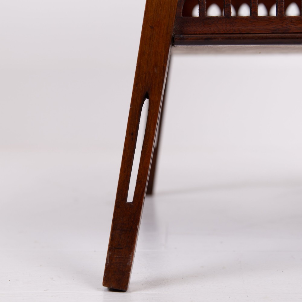 A late Victorian two-tier walnut side table featuring square splayed legs and a lower shelf enclosed by a pierced fretwork gallery. View III