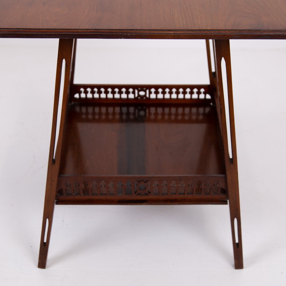 A late Victorian two-tier walnut side table featuring square splayed legs and a lower shelf enclosed by a pierced fretwork gallery. View VIII