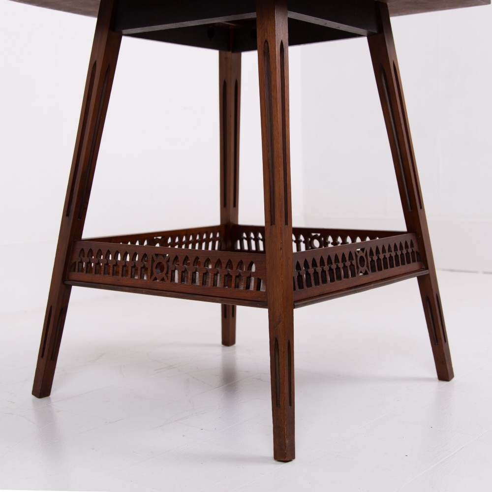A late Victorian two-tier walnut side table featuring square splayed legs and a lower shelf enclosed by a pierced fretwork gallery. View IX