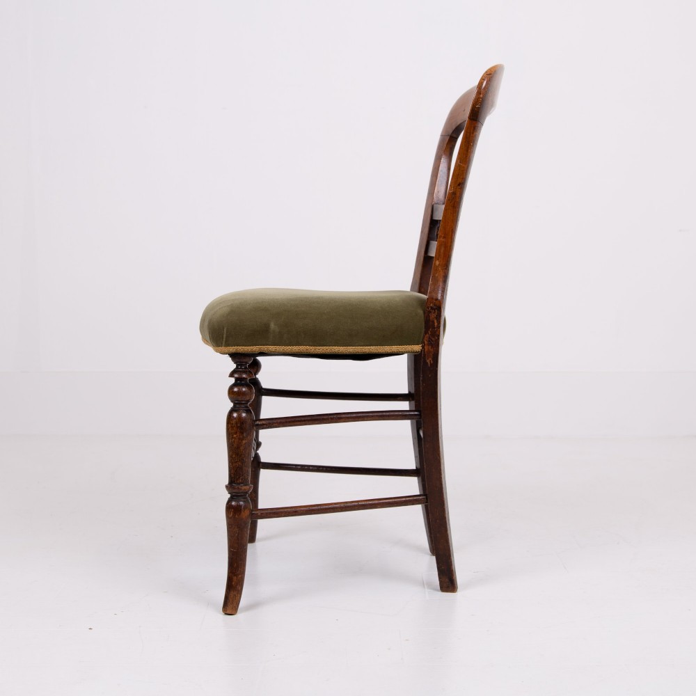 A set of six late Victorian wooden dining chairs featuring curved open backrests with spindle galleries, turned front legs, and olive green velvet seats. View XII
