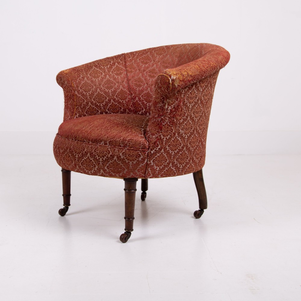 A pair of 19th-century Victorian tub armchairs upholstered in patterned red fabric with turned wooden legs on brass castors. View III