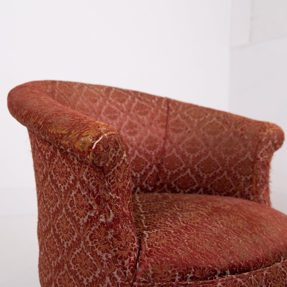 A pair of 19th-century Victorian tub armchairs upholstered in patterned red fabric with turned wooden legs on brass castors. View IX