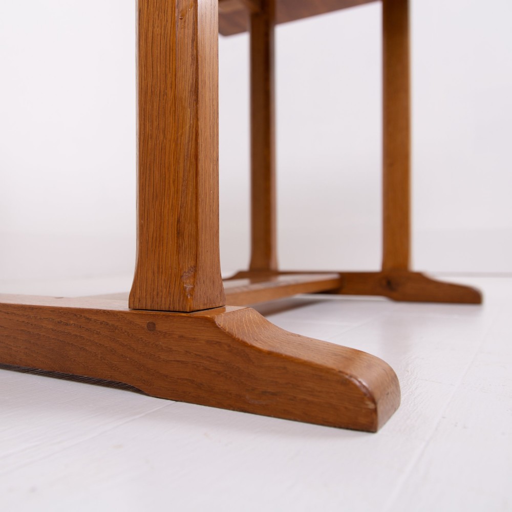 A 1930s Heals oak dining table featuring a rectangular solid timber top supported by a double-upright trestle base. View V