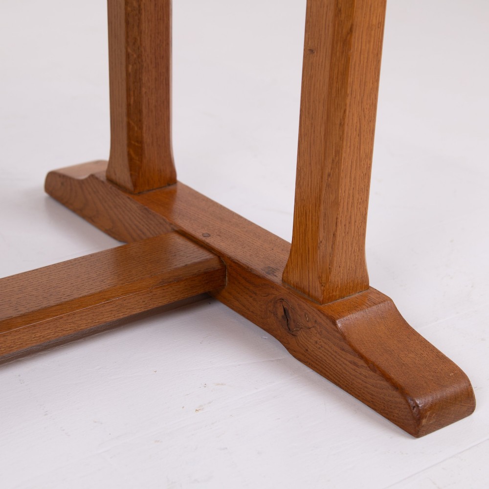 A 1930s Heals oak dining table featuring a rectangular solid timber top supported by a double-upright trestle base. View VI