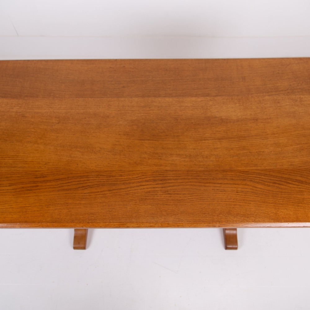 A 1930s Heals oak dining table featuring a rectangular solid timber top supported by a double-upright trestle base. View VII
