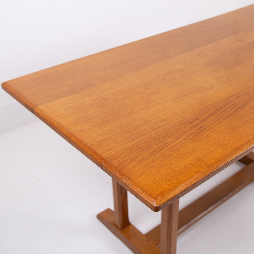 A 1930s Heals oak dining table featuring a rectangular solid timber top supported by a double-upright trestle base. View VIII