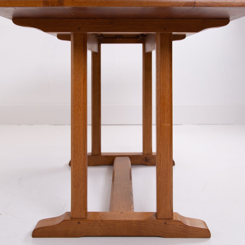 A 1930s Heals oak dining table featuring a rectangular solid timber top supported by a double-upright trestle base. View IX