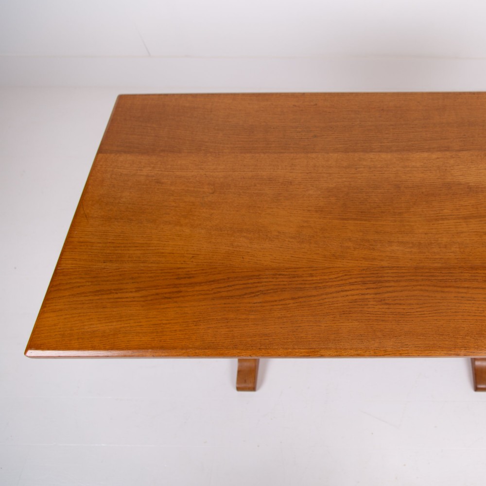 A 1930s Heals oak dining table featuring a rectangular solid timber top supported by a double-upright trestle base. View XI