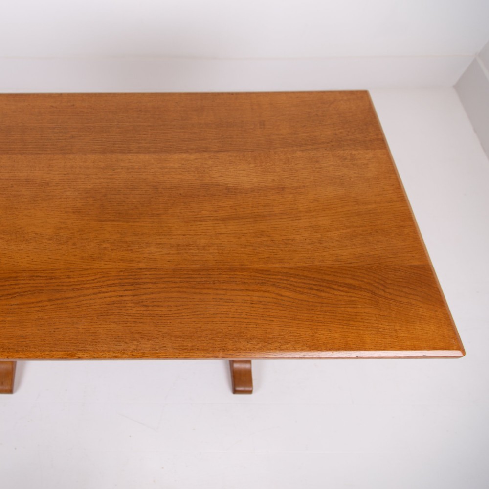 A 1930s Heals oak dining table featuring a rectangular solid timber top supported by a double-upright trestle base. View XII