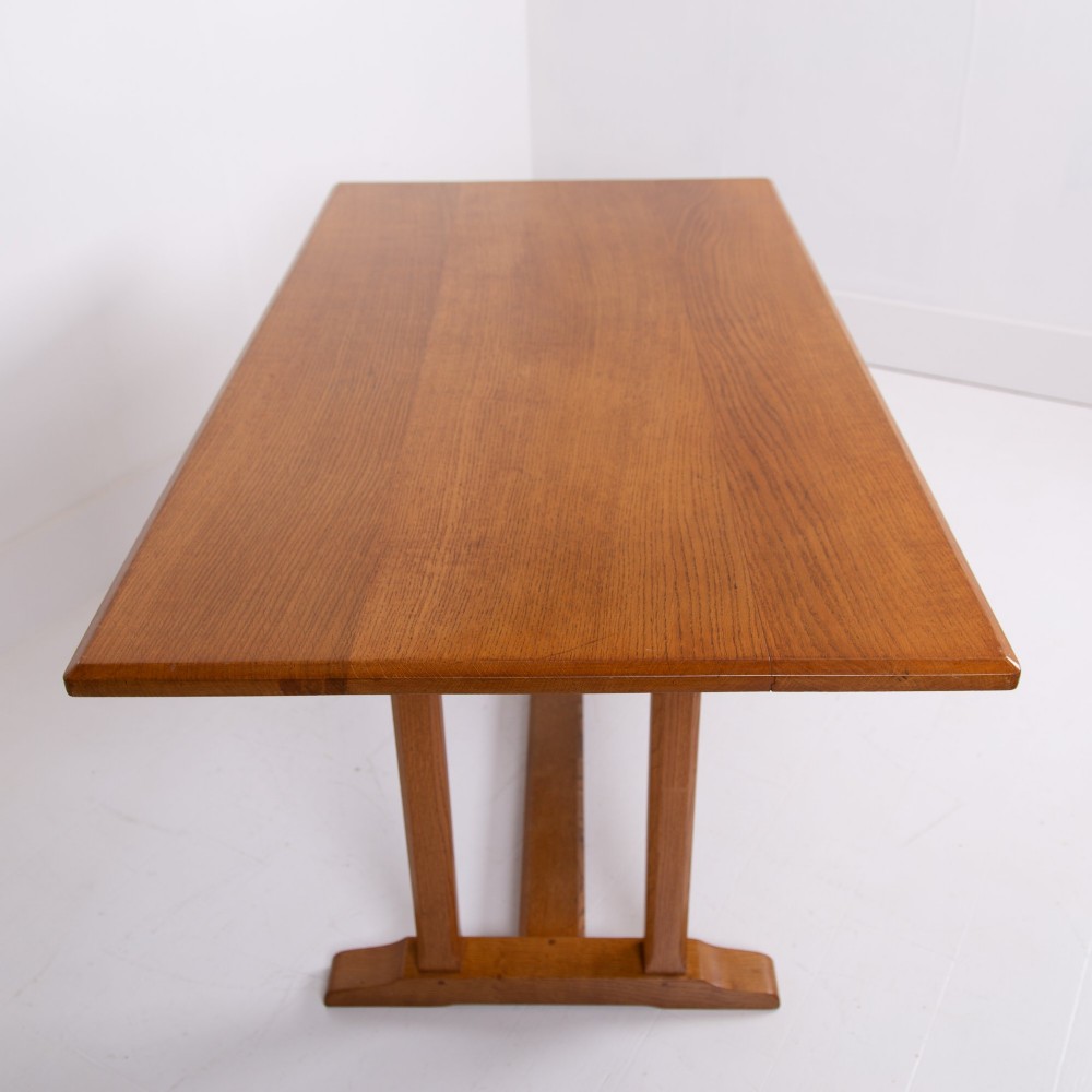 A 1930s Heals oak dining table featuring a rectangular solid timber top supported by a double-upright trestle base. View XIII