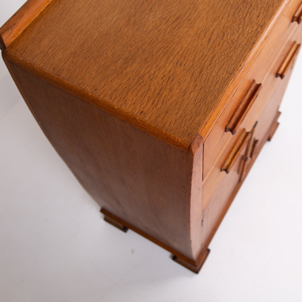 A 1930s Art Deco medium brown oak tallboy cabinet featuring two upper drawers with carved wooden handles and a double-door cupboard below. View VIII