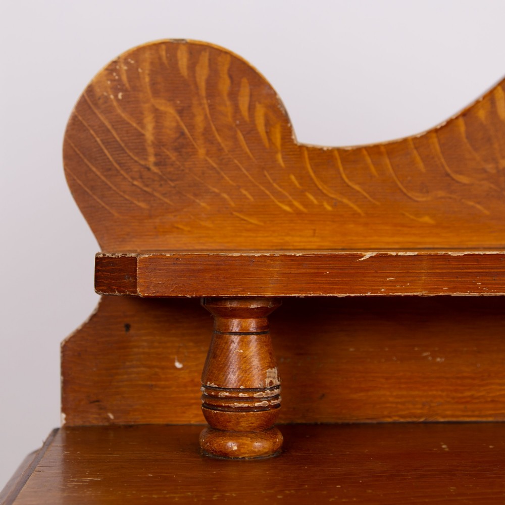 A Victorian scumble-painted pine kitchen dresser with three drawers, a cupboard door, turned knobs, and a galleried splashback shelf. View IV