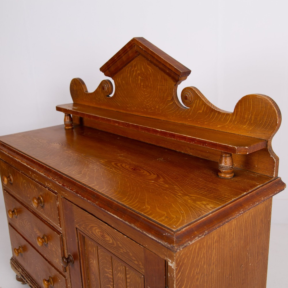 A Victorian scumble-painted pine kitchen dresser with three drawers, a cupboard door, turned knobs, and a galleried splashback shelf. View VI