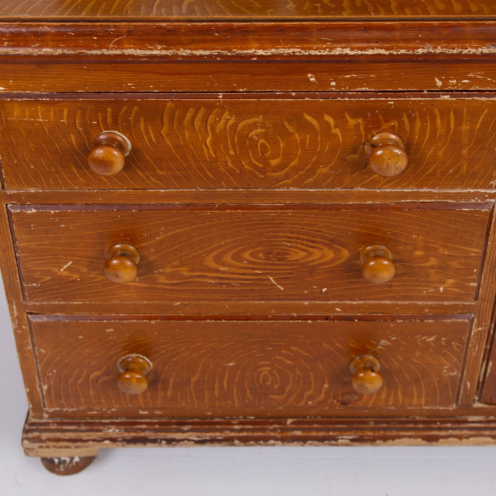 A Victorian scumble-painted pine kitchen dresser with three drawers, a cupboard door, turned knobs, and a galleried splashback shelf. View XI