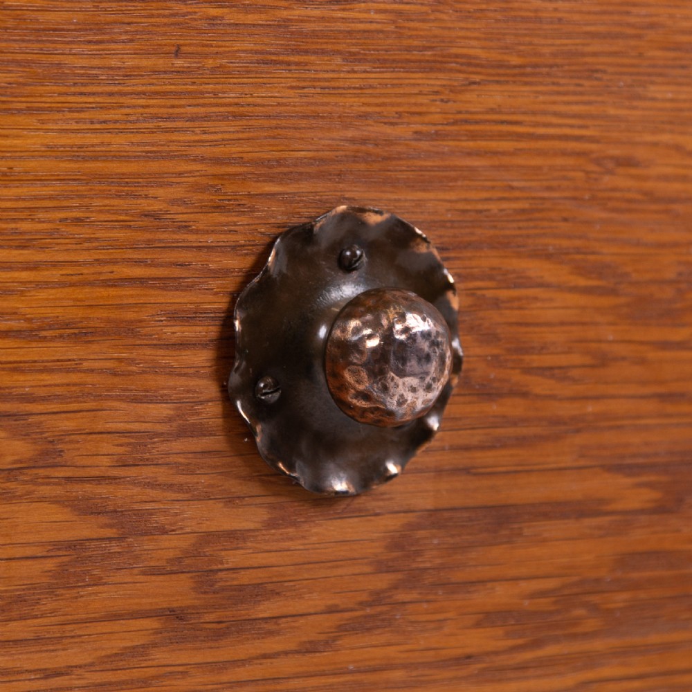 An Arts and Crafts oak dressing chest featuring a superstructure with a central mirror, inlaid side panels, and small jewellery drawers above a chest of drawers. View VIII