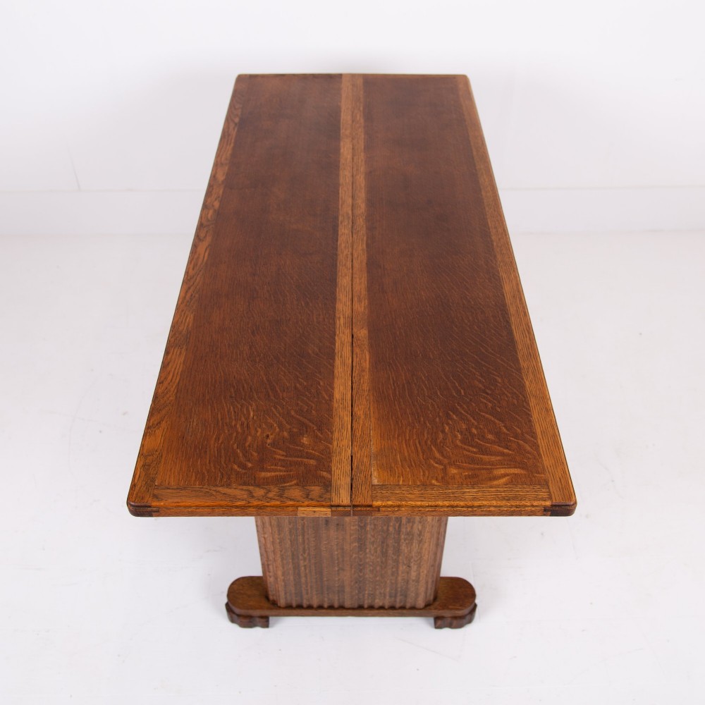 An Art Deco medium oak dining set comprising a rectangular pedestal table and four matching chairs with brown leather seats. View IV