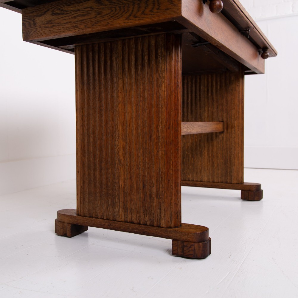 An Art Deco medium oak dining set comprising a rectangular pedestal table and four matching chairs with brown leather seats. View XI