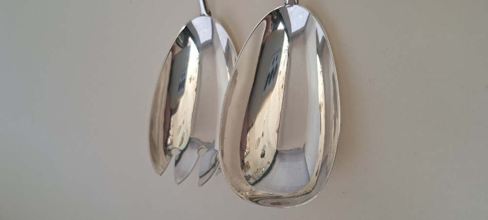 A circular cut crystal salad bowl with a silver rim, accompanied by a pair of silver and crystal-handled salad servers. View XII