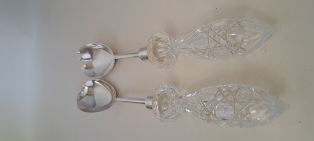 A circular cut crystal salad bowl with a silver rim, accompanied by a pair of silver and crystal-handled salad servers. View XIII