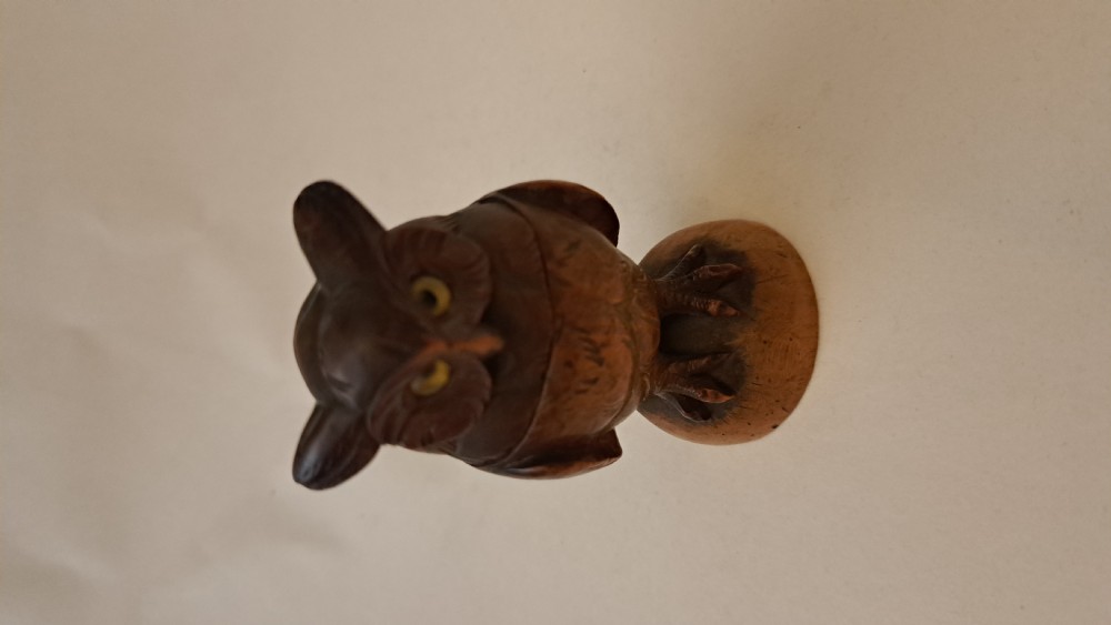 A small carved wooden owl inkwell featuring glass eyes and perched on a circular wooden base against a neutral background. View II