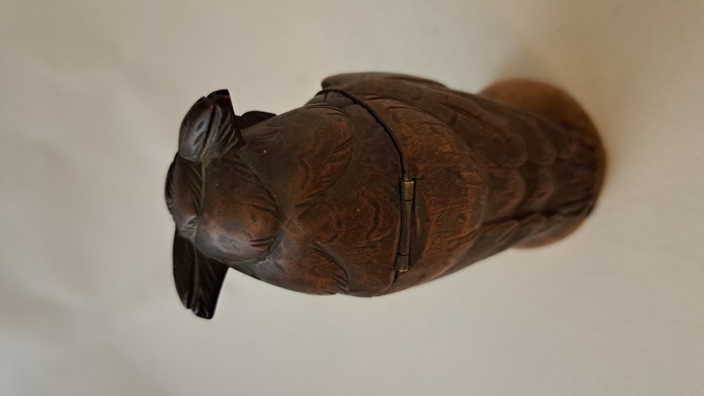 A small carved wooden owl inkwell featuring glass eyes and perched on a circular wooden base against a neutral background. View VI