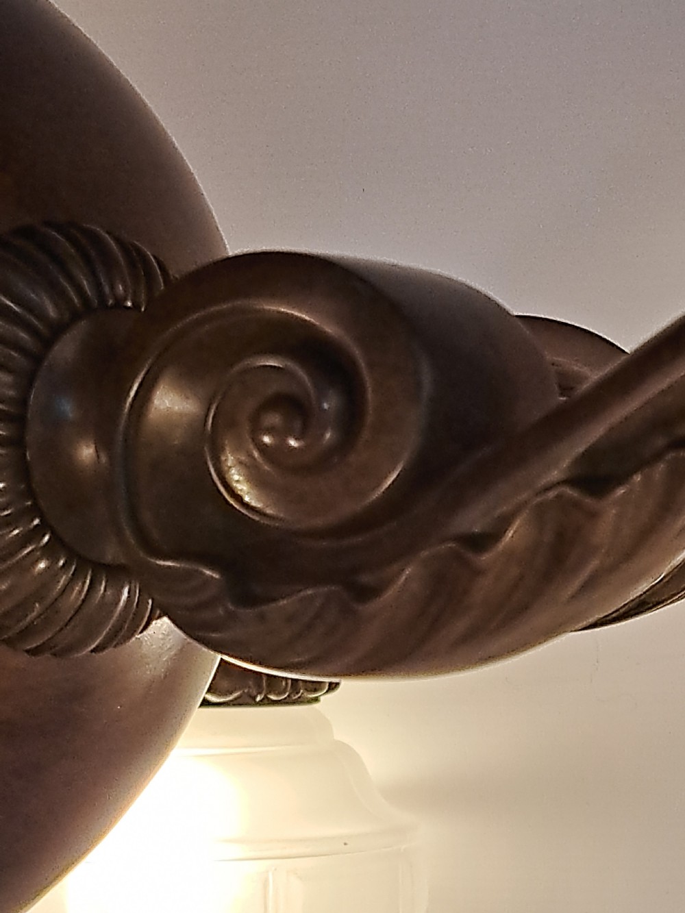 A five-arm dark bronze chandelier featuring a central turned stem, curved scroll arms, and downward-facing frosted glass shades. View IX