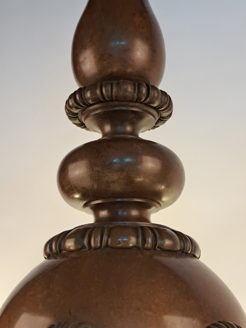 A five-arm dark bronze chandelier featuring a central turned stem, curved scroll arms, and downward-facing frosted glass shades. View XI